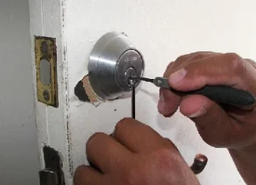 Emergency locksmith unlocking door during lockout in Crawley